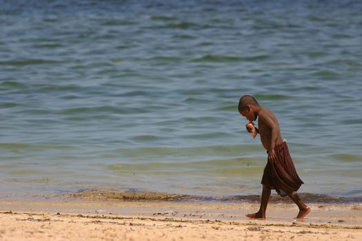 Young boy walking along the beach at Ifaty