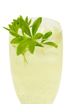 Punch with sweet woodruff herbs on bright background