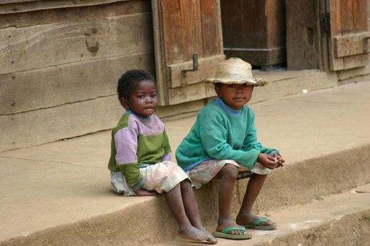 Two kids in Madagascar spending the time watching the world go by