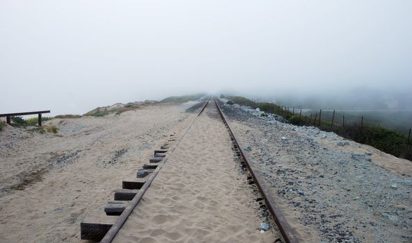 Railroad near California coast disappearing in the Fog.