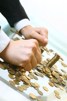 hand make coins piles on white