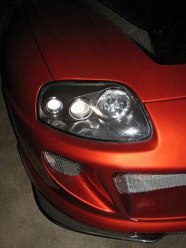 front headlight, hood, and front fascia (body kit) of a sporty Japanese import car - all souped up