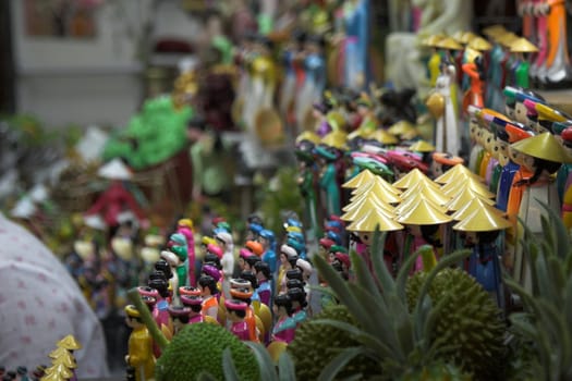 Selling vietnamese puppets at a stall at a market in vietnam