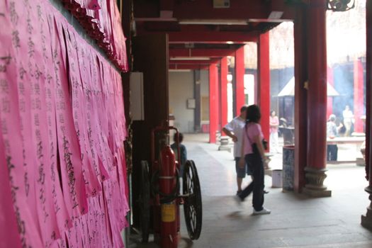 Religious papers on the wall in a temple in Chinatown, Saigon