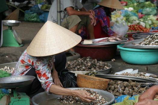 Woman at a market in Chinatown preparing her merchandise