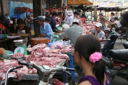 People looking for fresh meat at a butcher in Chinatown, Saigon