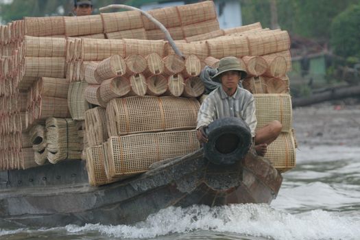 Bringing his ware to the floating market, Mekong Delta, Vietnam