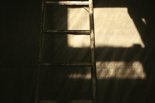 ladder in a dark work area.