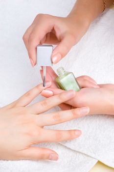 applying manicure: moisturizing the nails and skin around