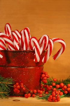 Candycanes and berries in  a red old tin can