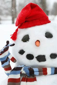 Smiley face snowman with a red hat