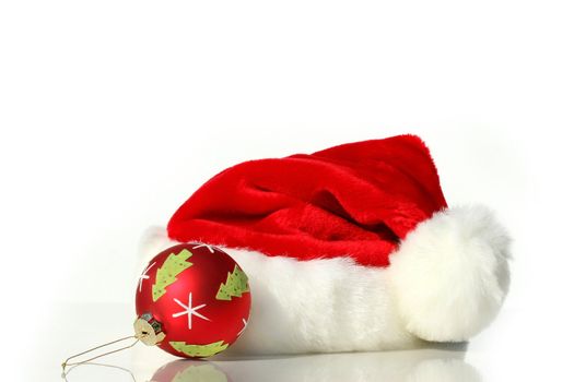 Santa hat with red christmas ball isolated on white background