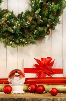 Holiday wreath with snow globe and red christmas balls