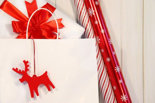 Paper shopping bag filled with gift and wrapping paper
