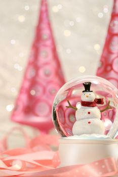 Snow globe with pink christmas trees in a winter white background