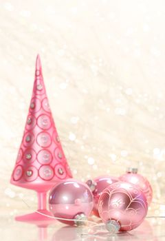 Pink holiday tree with glass balls and simmering background