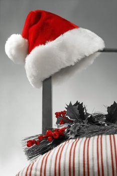 Santa hat hanging on the side of a chair  Selective B/W