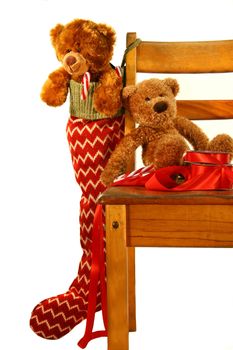 Teddy bears placed on an  old school chair waiting for Christmas