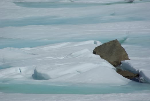 Spring ice breakup and rocks on a high Sierra lake.