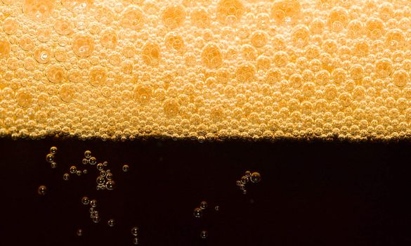 close-up dark beer with foam