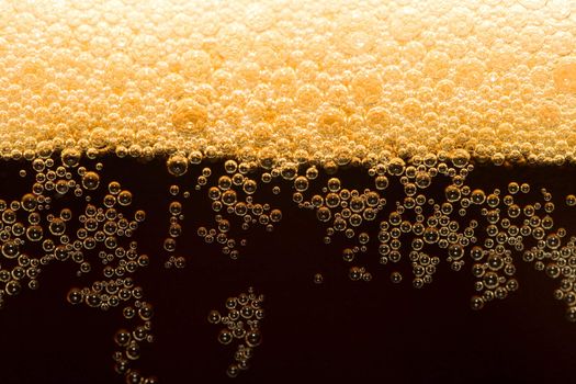 appetizing filtered dark beer with foam