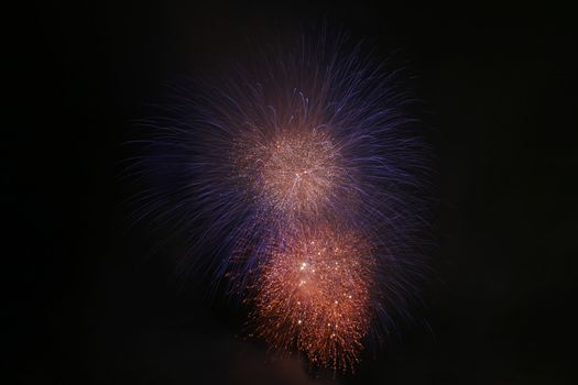 silky blue and fiery orange fireworks at night
