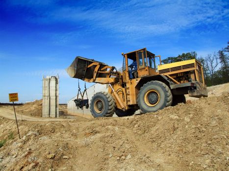 Front loader unloading concrete rubble on urban construction site