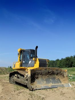 Front loader unloading concrete rubble on urban construction site