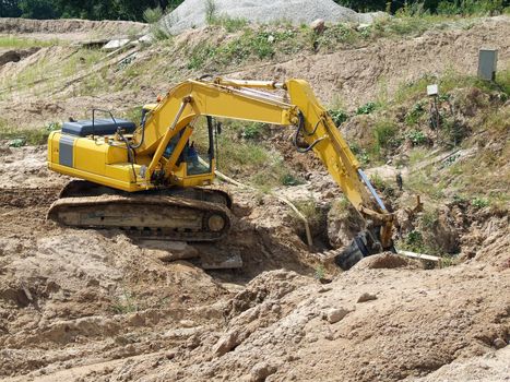 Yellow excavator at construction site