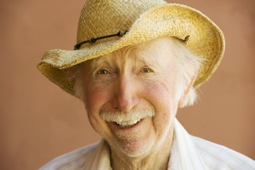 Senior Citizen Man Smiling in a Straw Cowboy Hat