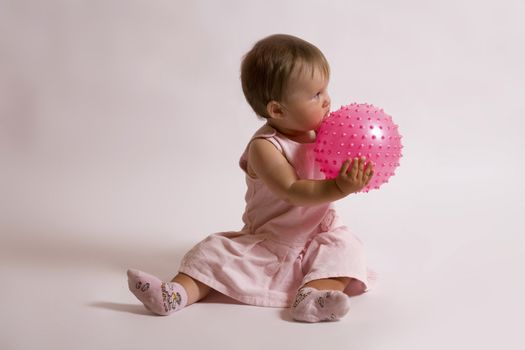 eight month little girl and pink ball