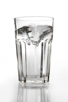 A glass of water on a reflective surface