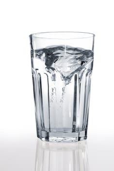 A glass of water on a reflective surface