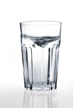 A glass of water on a reflective surface