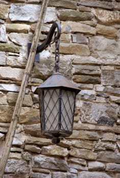 authentic historical lamp on the stone wall