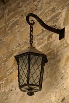 authentic historical lamp on the stone wall