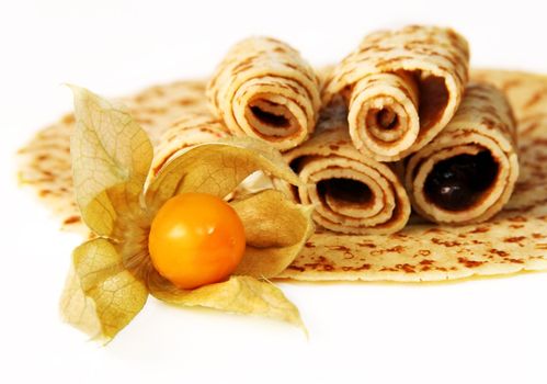Pancakes on a plate and yellow berry