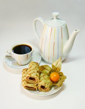 The curtailed braided, a teapot and a cup from coffee on a white background