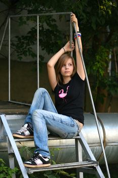 Teenage girl siiting against wall in a depressed state