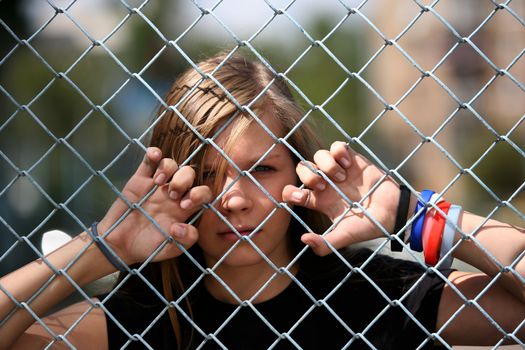 The young girl behind a lattice