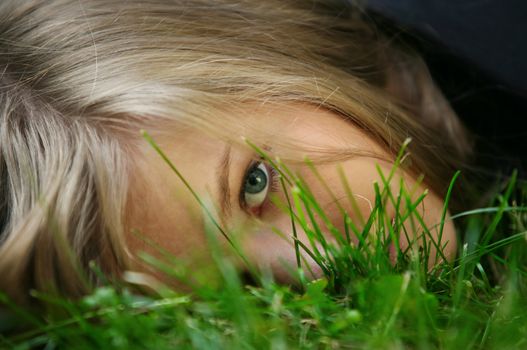 The girl in a grass. The face close-up