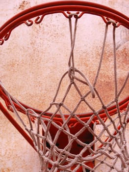 A closeup of a playground basketball goal and net.