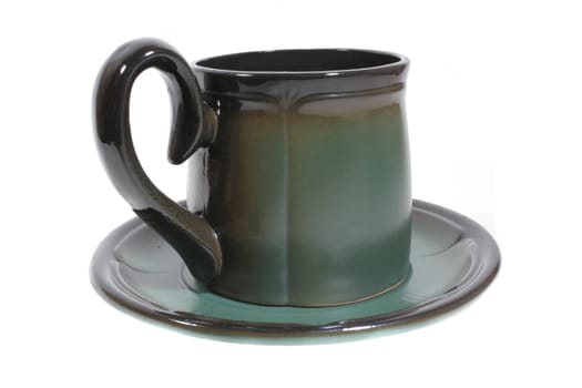 Large green ceramic tea cup on saucer