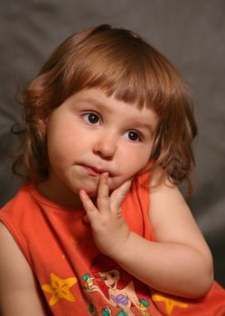 Portrait of the two-year-old girl with an amusing grimace