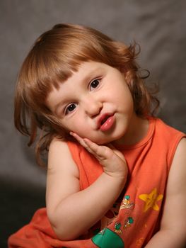 Portrait of the two-year-old girl with an amusing grimace