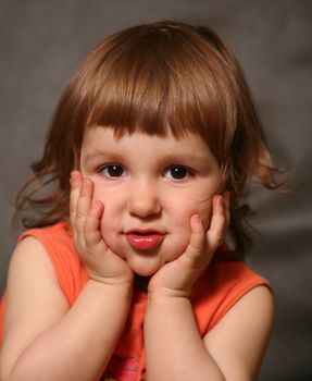 Portrait of the two-year-old girl with an amusing grimace