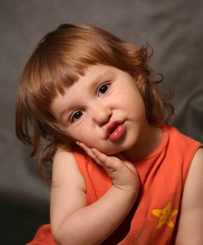 Portrait of the two-year-old girl with an amusing grimace