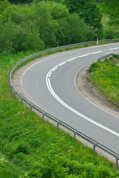 Country road with painted double lines going up hill