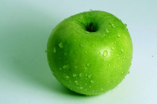 green fresh apple and waterdrops from it