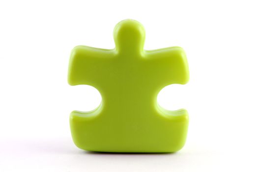 One green puzzle piece isolated on white